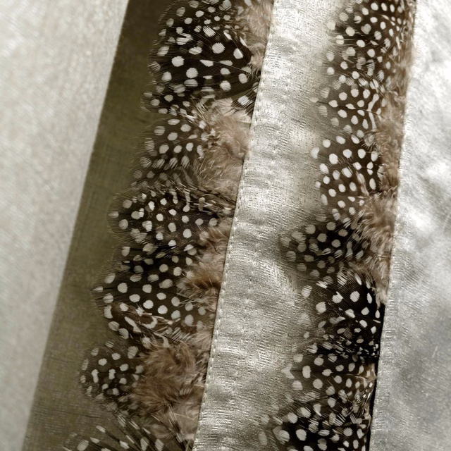 Olive and silver fabric with spotted guinea feathers and a softly textured sheen