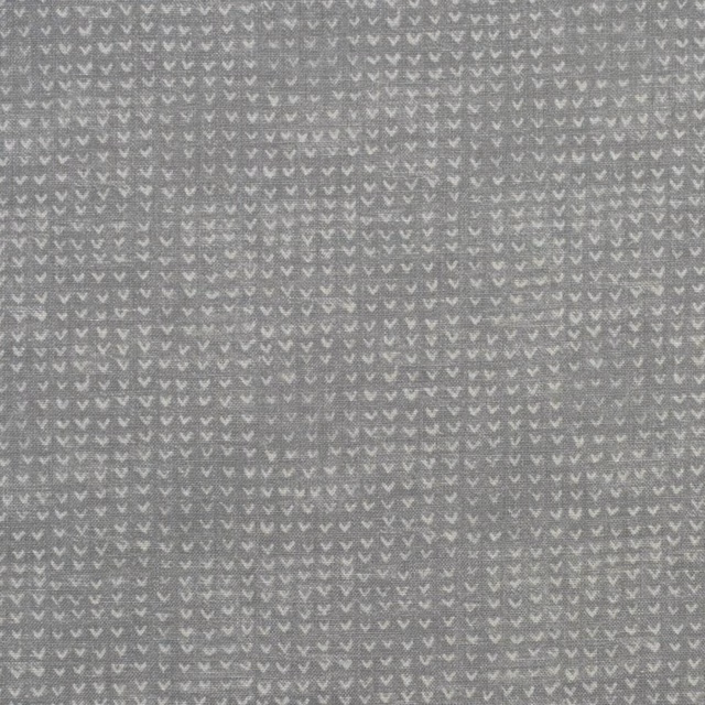 Storm-grey woven fabric with tiny pale chevrons and a softly textured surface