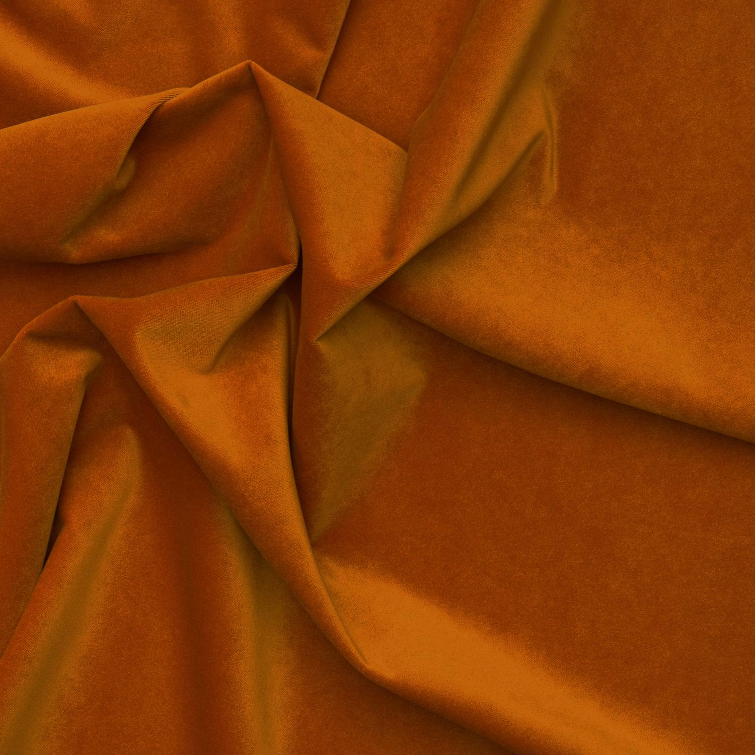 Burnt-orange outdoor velvet draped in folds, showing plush texture and amber highlights