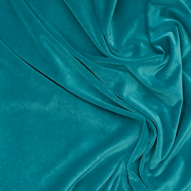 Saturated turquoise teal velvet with luminous sheen across softly gathered folds
