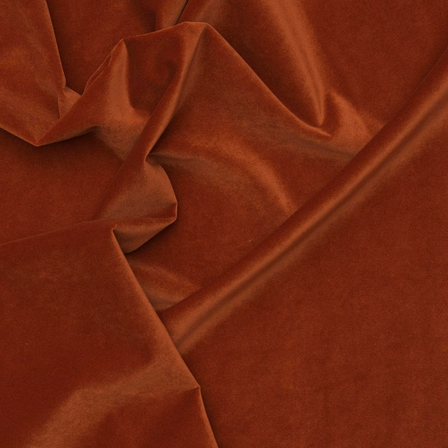 Burnt terracotta outdoor velvet swatch with plush folds and coppery highlights
