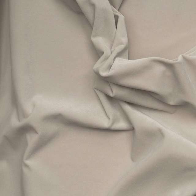 Soft stone taupe outdoor velvet with a smooth nap folded into deep sculptural creases