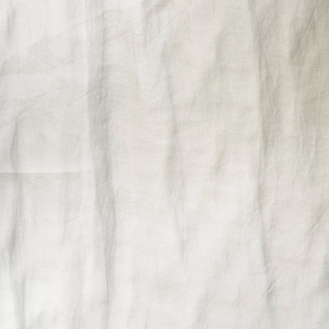 Pale ivory cream textile with crinkled vertical texture and softly translucent tonal variation