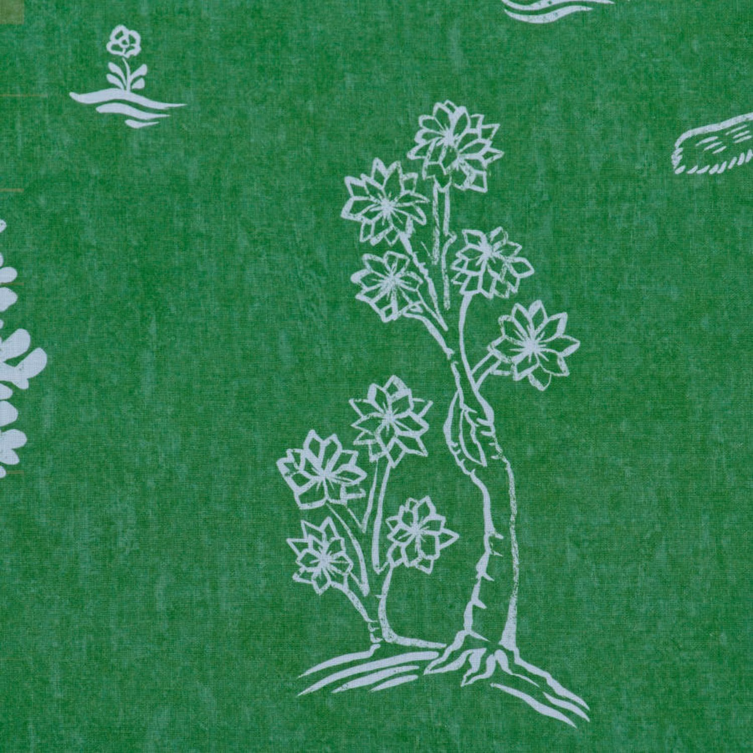Basil green textile with chalk-white folk flowers and a branching botanical motif