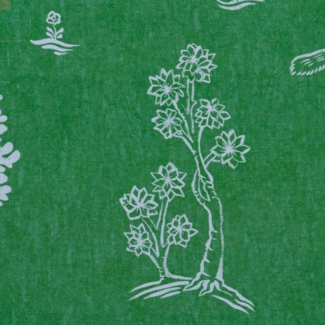 Basil green textile with chalk-white folk flowers and a branching botanical motif