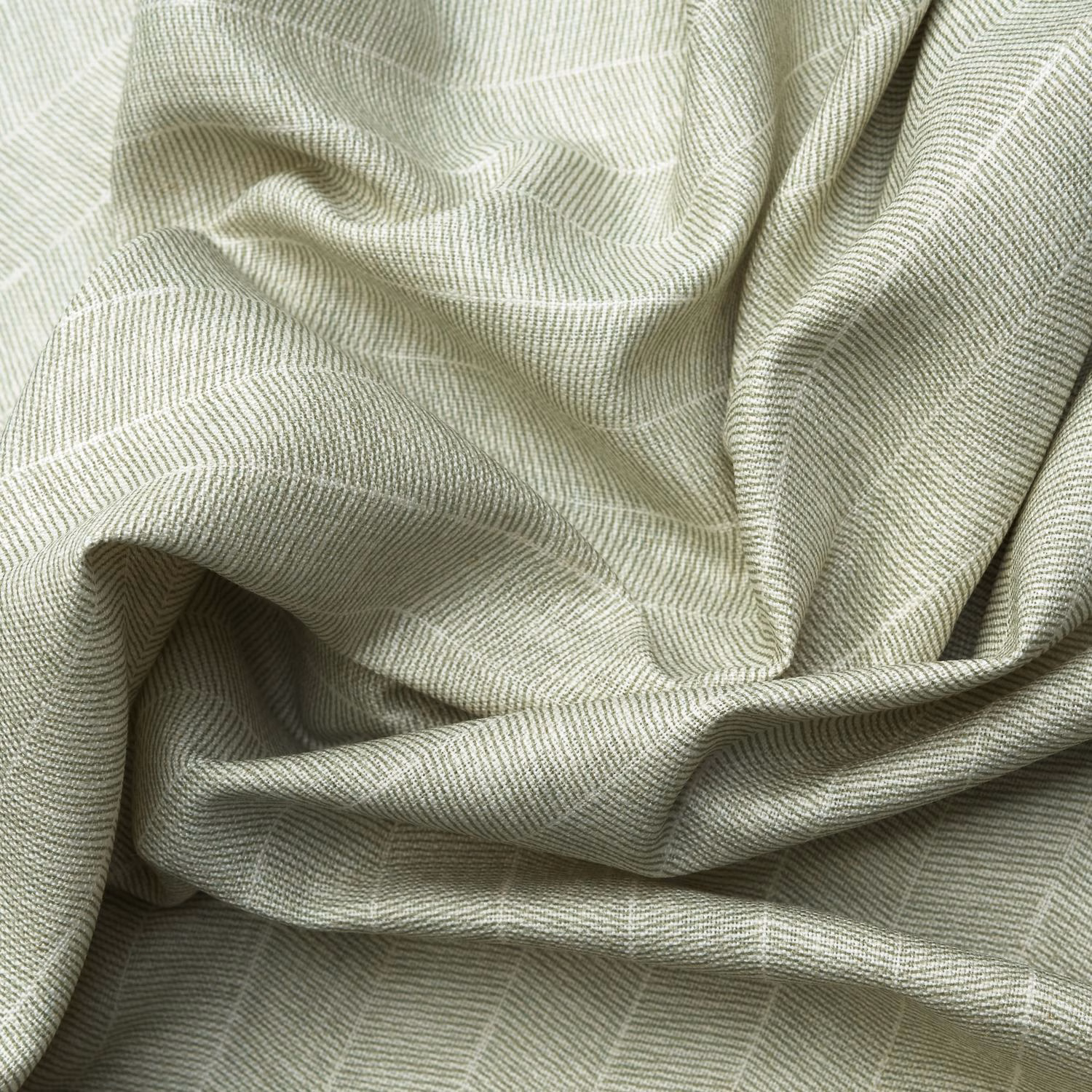 Pale fennel-green ribbed textile with fine zigzag weave gathered into soft folds