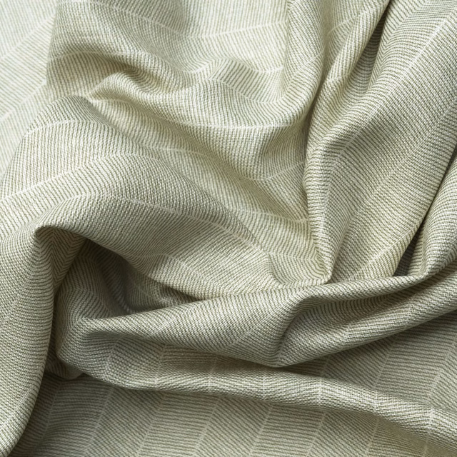 Pale fennel-green ribbed textile with fine zigzag weave gathered into soft folds