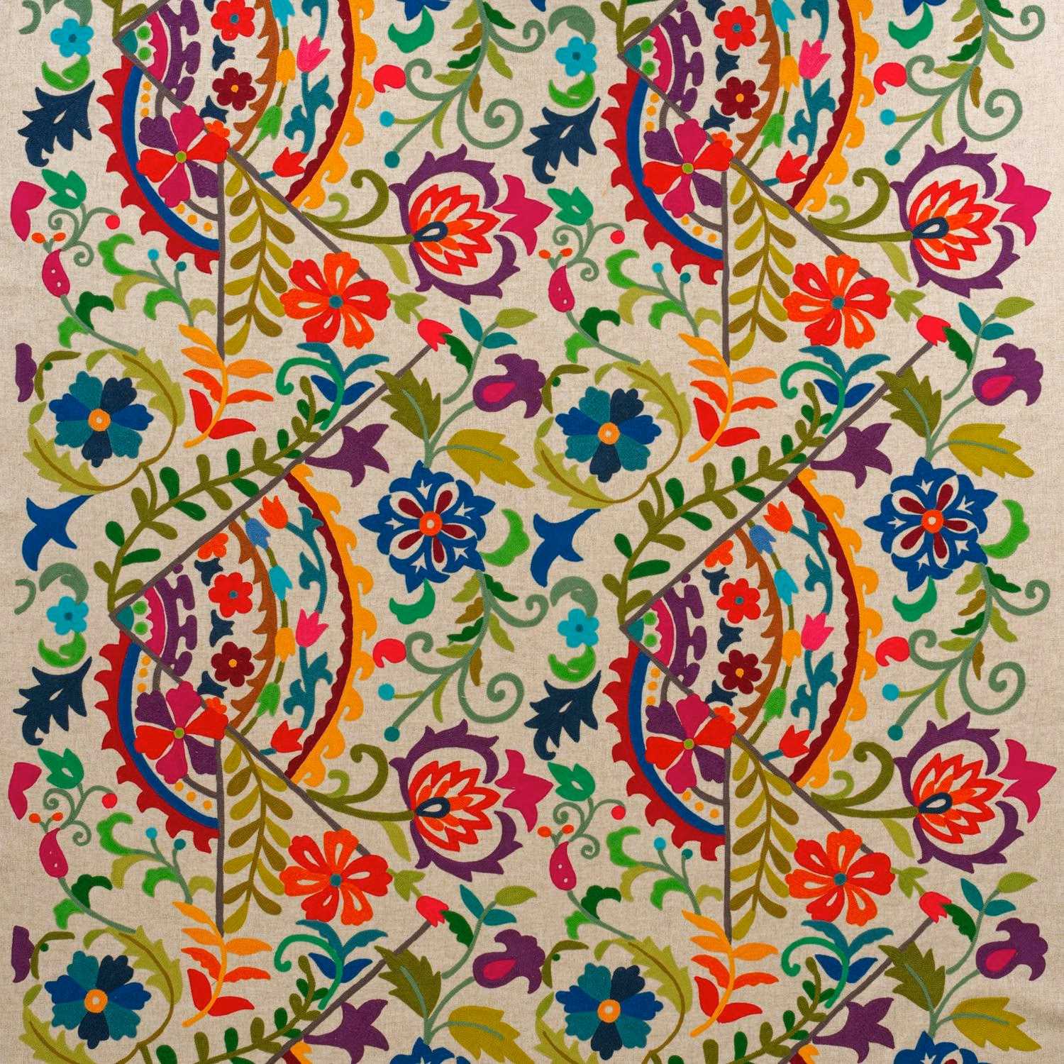 Cream embroidered fabric with vivid red, blue, green and purple floral foliage