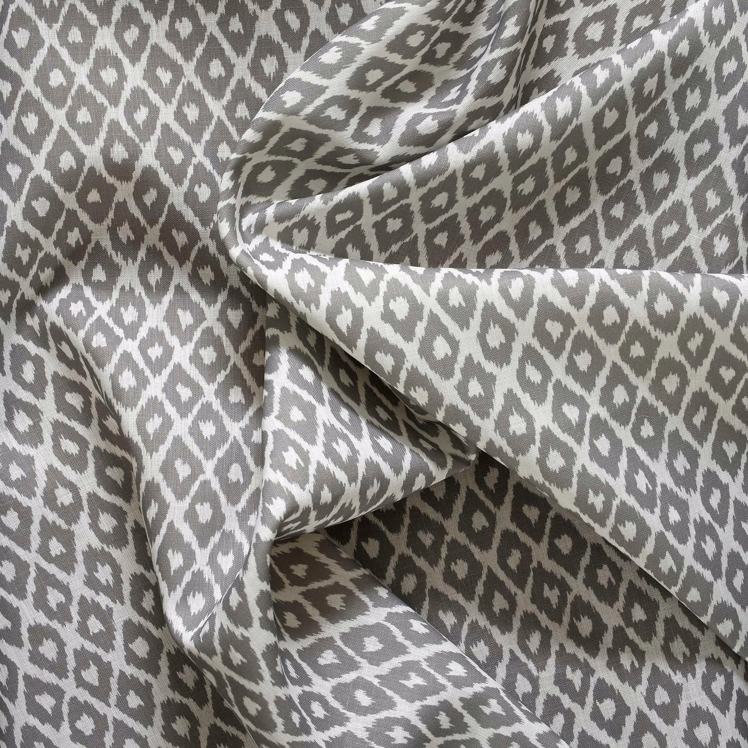 Cool grey and white outdoor fabric with irregular diamond motifs and a softly textured weave