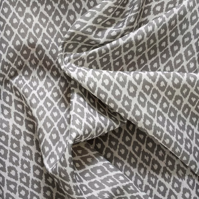 Cool grey and white outdoor fabric with irregular diamond motifs and a softly textured weave