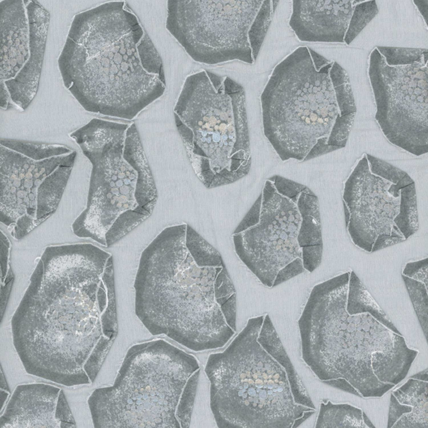 Cool grey fabric with charcoal faceted mineral shapes and pale blue flecks