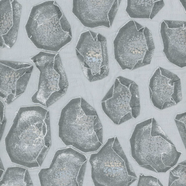 Cool grey fabric with charcoal faceted mineral shapes and pale blue flecks