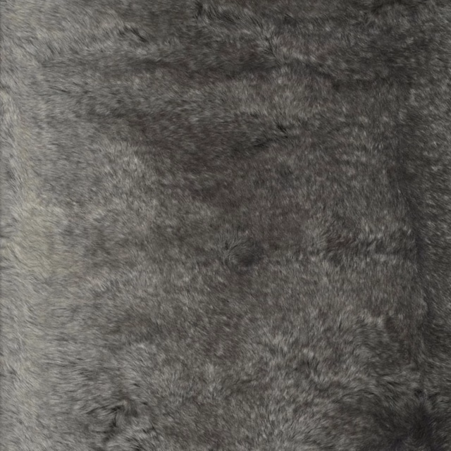 Close-up of charcoal-grey plush fabric with mottled directional pile and soft tonal variation