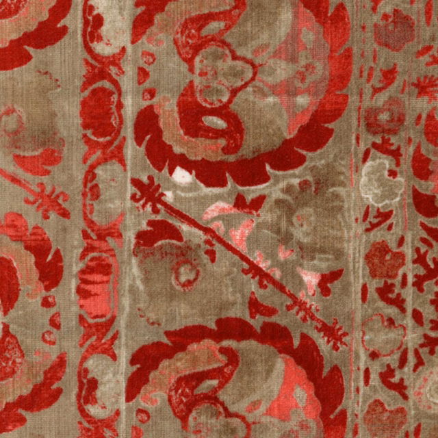 Aged red floral medallions and borders on a taupe textured woven fabric
