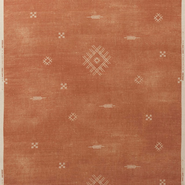 Brick-red woven fabric with ivory diamond, cross and arrow motifs