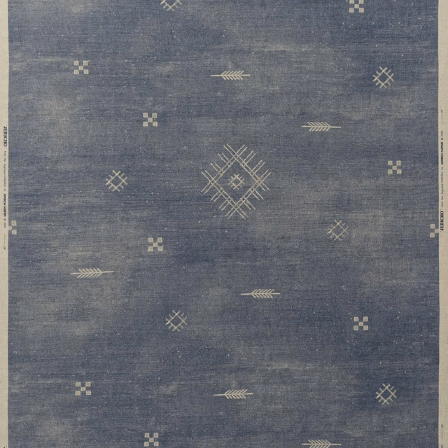 Muted denim-blue woven ground with cream geometric diamonds and arrow motifs