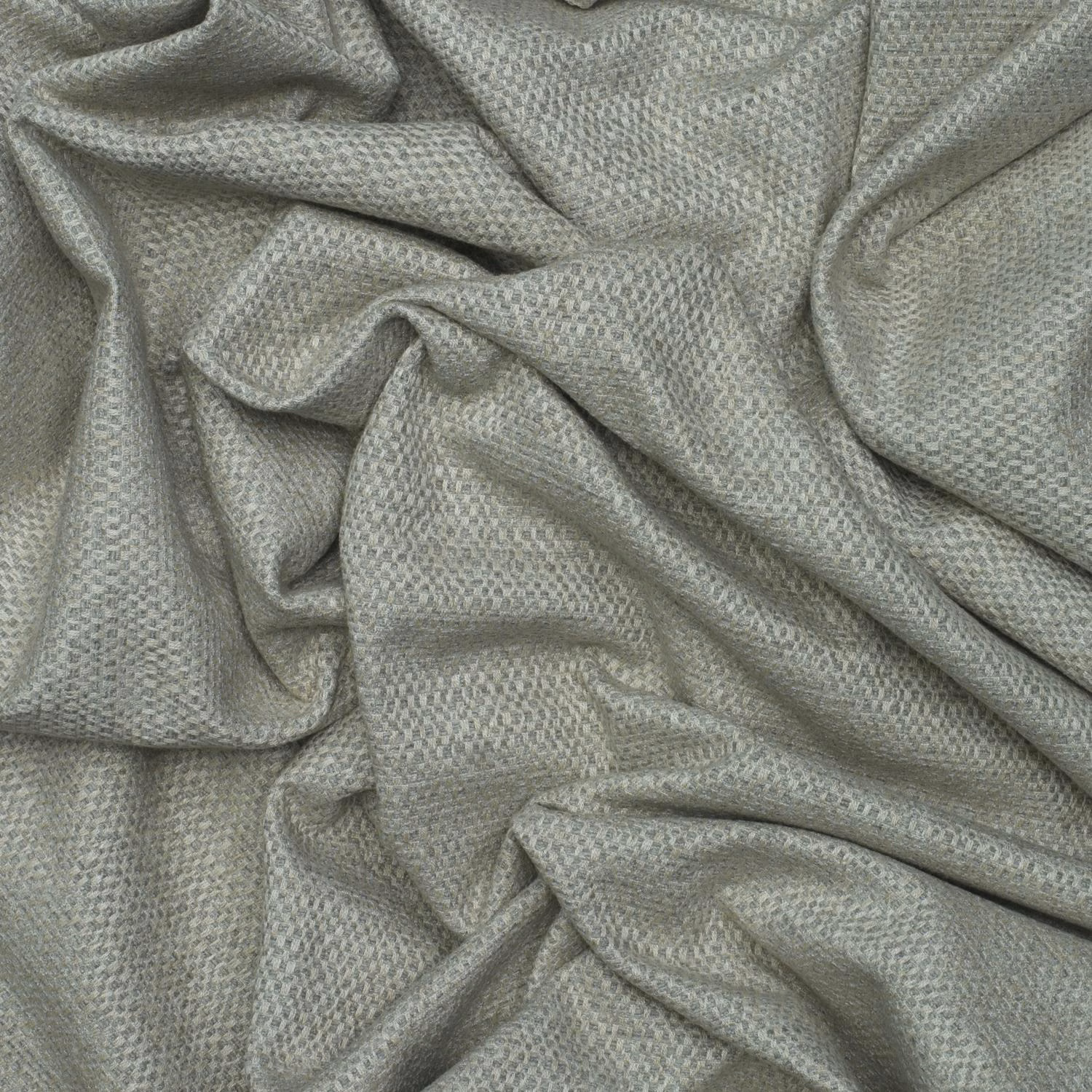 Cool grey woven textile with fine pebbled texture gathered into soft folds