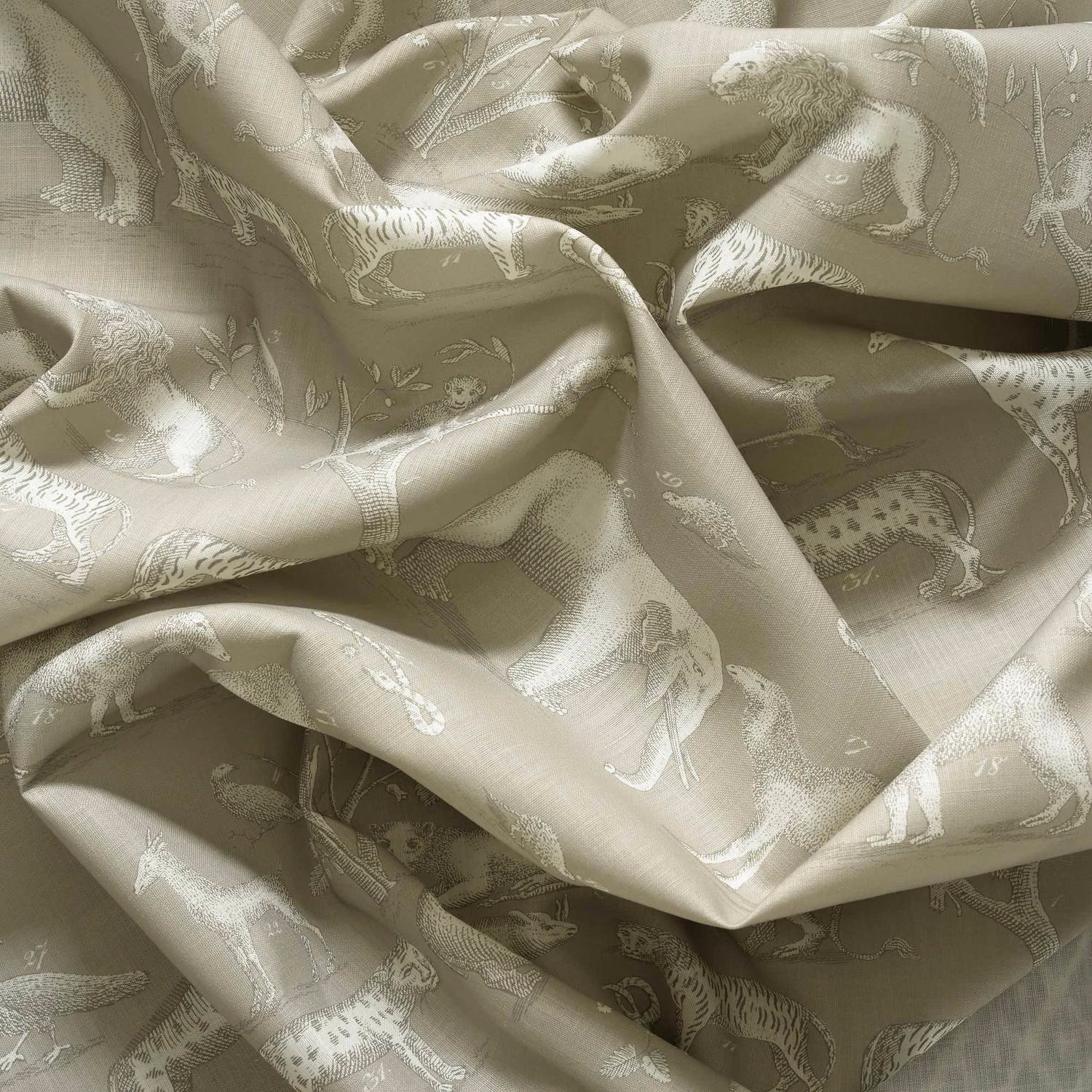 Mushroom taupe jacquard showing pale animal figures and soft sheen across folded cloth