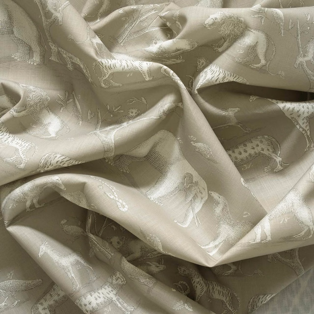 Mushroom taupe jacquard showing pale animal figures and soft sheen across folded cloth