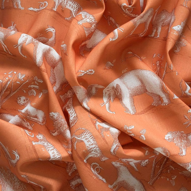 Warm terracotta fabric with pale safari animals, including elephants and striped big cats
