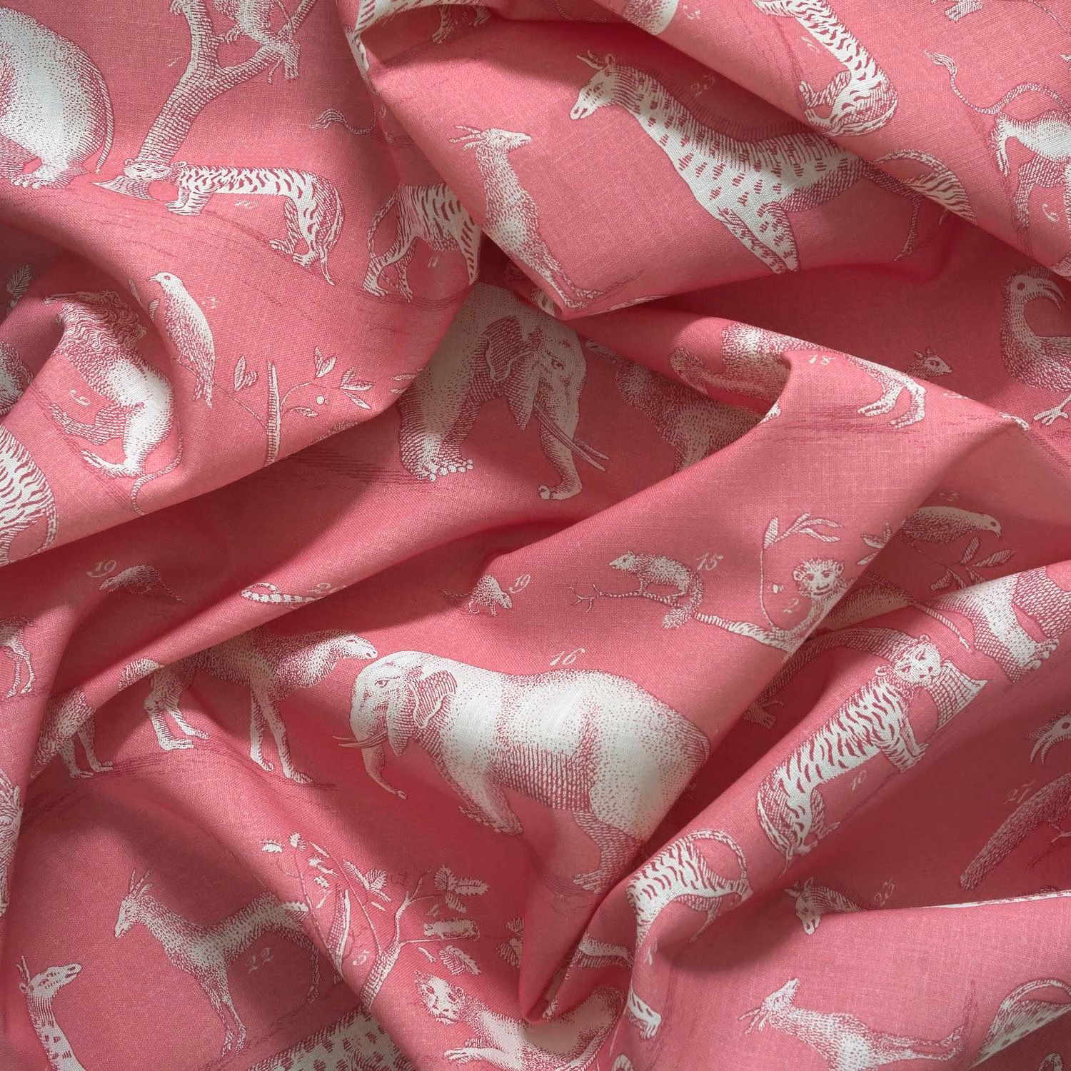 Dusty rose outdoor fabric with pale illustrated animals and softly textured folds