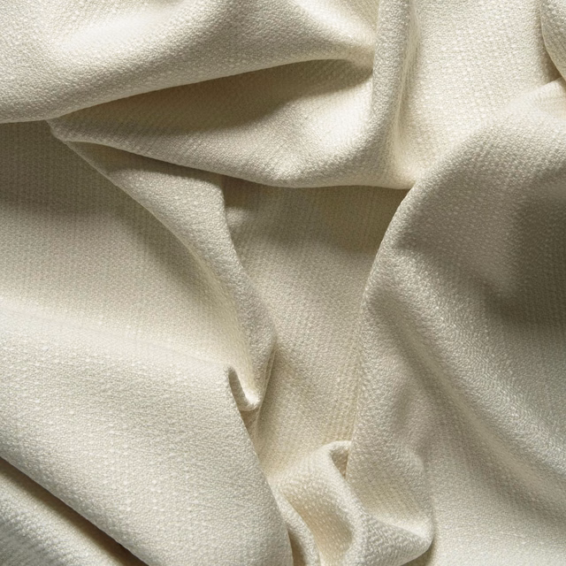 Warm ivory fabric with a fine pebbled weave gathered into soft folds