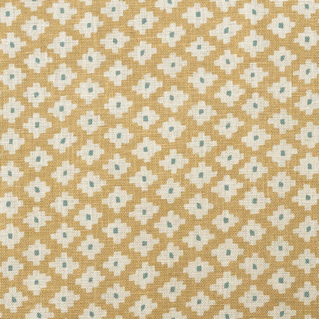 Honey-gold woven fabric with ivory quatrefoil motifs and pale blue-green centres