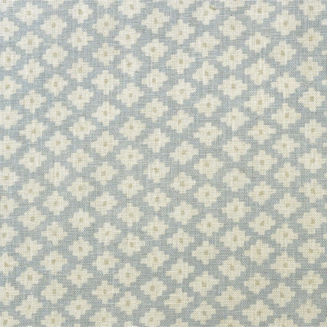 Soft sky-blue woven ground with repeating ivory geometric floral motifs