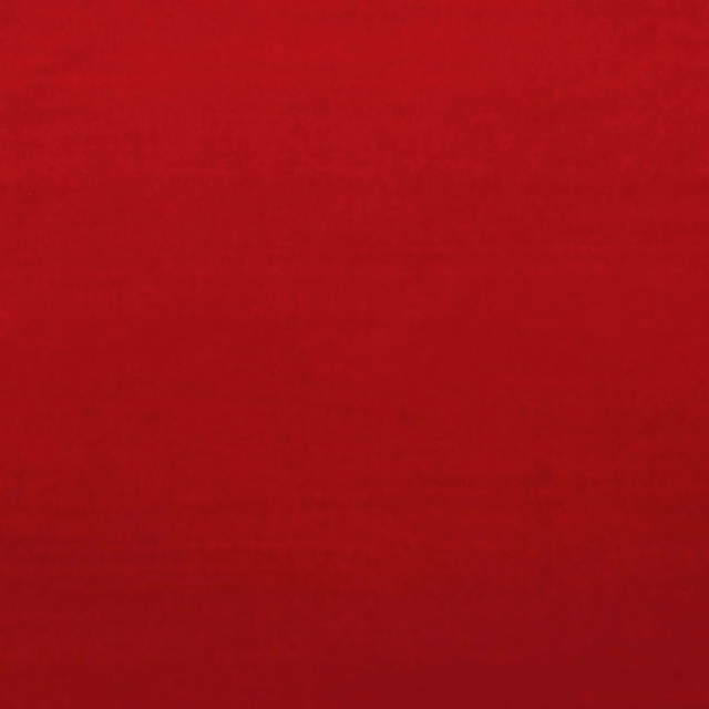 Deep burnt vermillion red velvet with subtle nap shading across the smooth surface