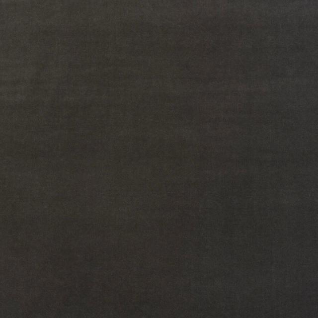 Close-up of plain deep charcoal cotton velvet showing a soft, subtly varied nap