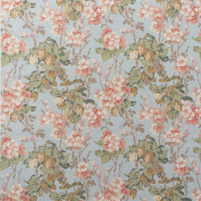 Pale sky-blue cotton print with blush blossoms, muted leaves and a softly visible weave