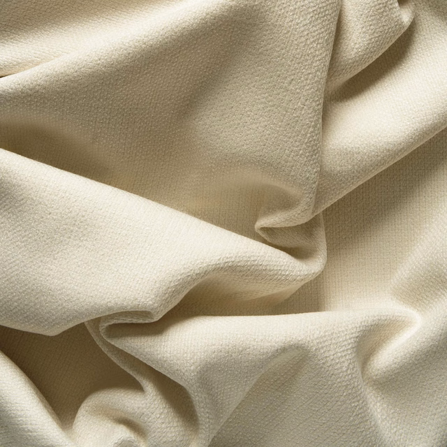 Warm ivory woven fabric with fine pebbled texture arranged in softly sculptural folds