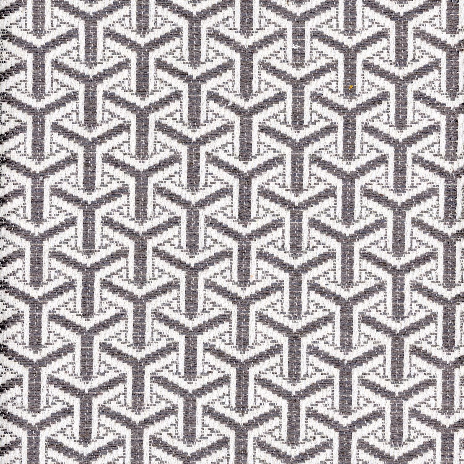 Charcoal and ivory woven fabric with a dense interlocking angular geometric pattern