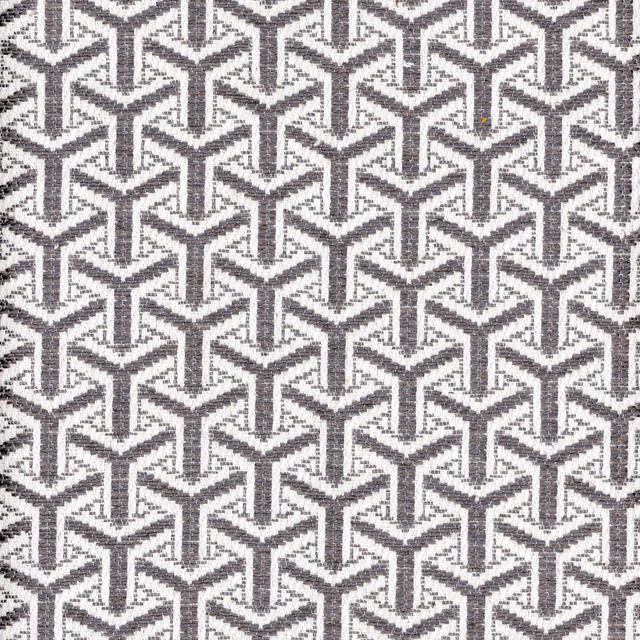 Charcoal and ivory woven fabric with a dense interlocking angular geometric pattern