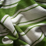 Bright meadow-green and ivory woven stripes gathered into a deeply textured swatch