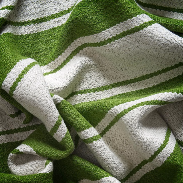 Bright meadow-green and ivory woven stripes gathered into a deeply textured swatch