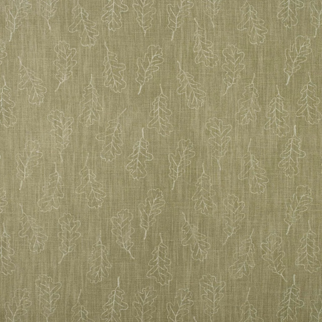 Muted lichen-olive woven fabric with pale outlined oak leaves and vertical slub texture