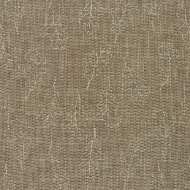 Warm taupe woven fabric with scattered ivory oak leaf outlines and textured slub