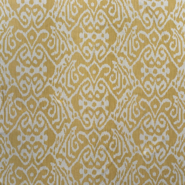 Warm barley-gold ikat curls over a pale otter-beige cotton ground