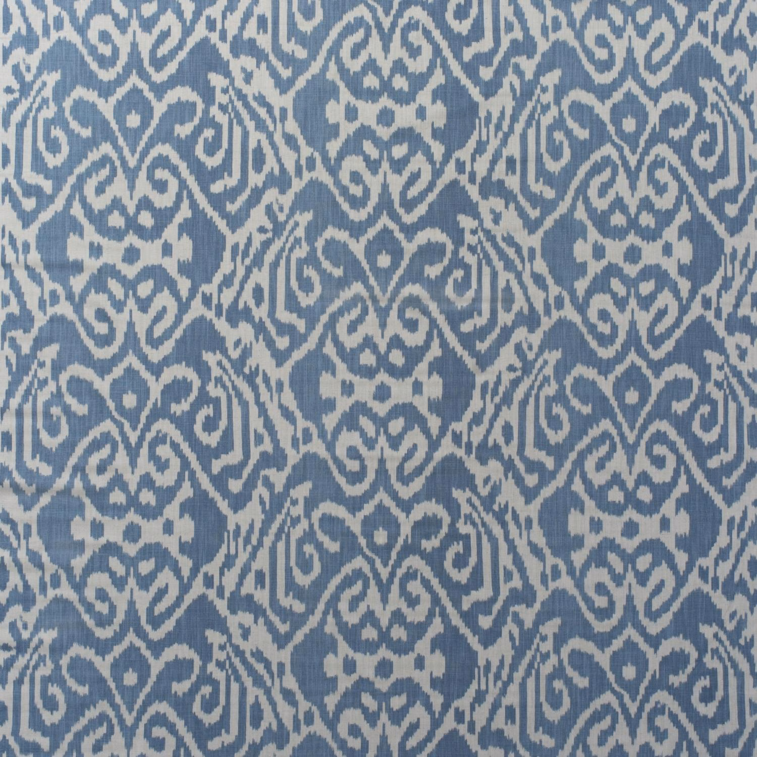 Muted denim-blue and ivory ikat motifs in a softly textured cotton print