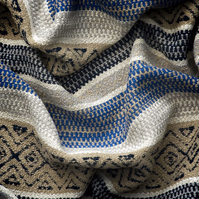 Indigo, cream and beige geometric woven fabric gathered into richly textured folds
