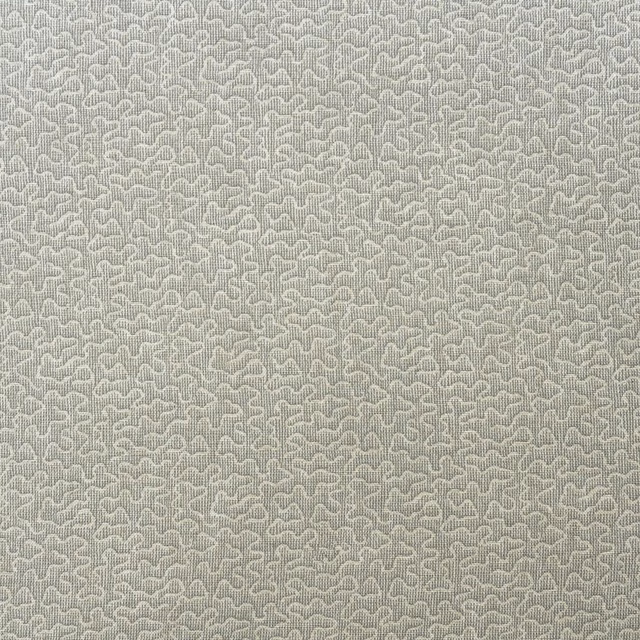 Pale mushroom-grey woven textile with tiny looping cloud-like motifs