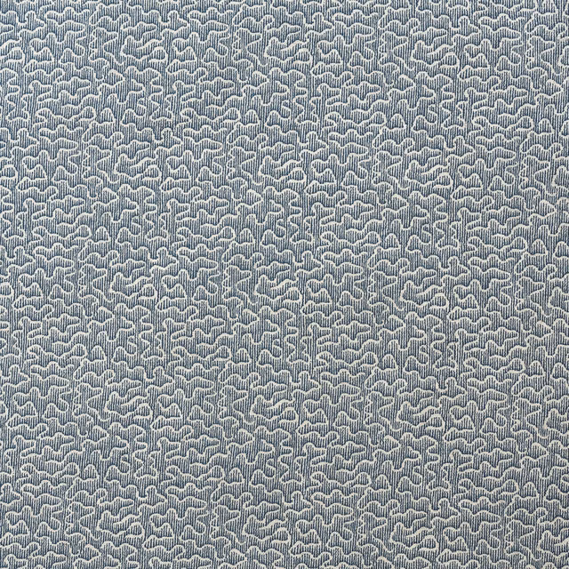 Muted denim-blue fabric with dense pale looped woven texture