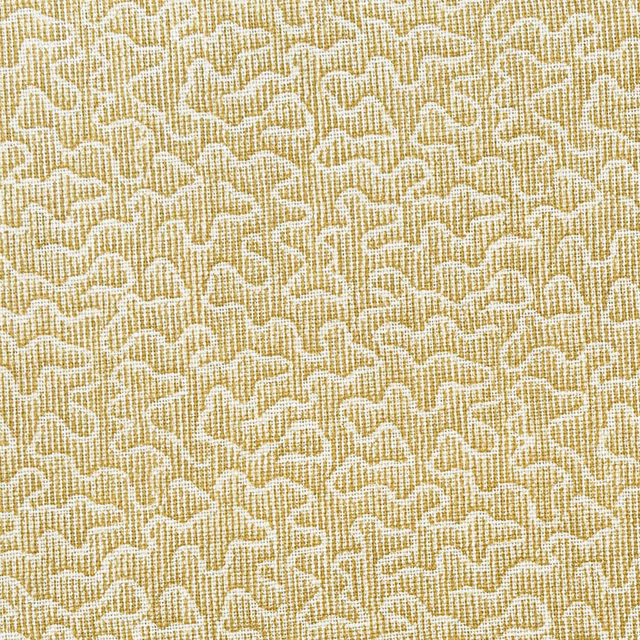 Honey-gold woven textile with fine ivory looping squiggles and a tactile grid texture