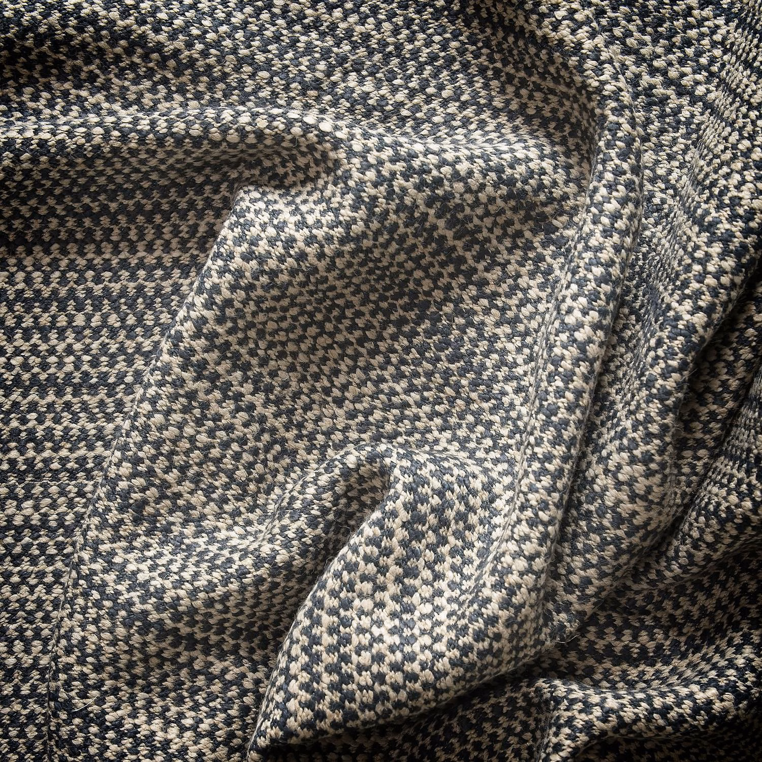 Charcoal and cream woven textile with tiny geometric flecks and sculptural folds