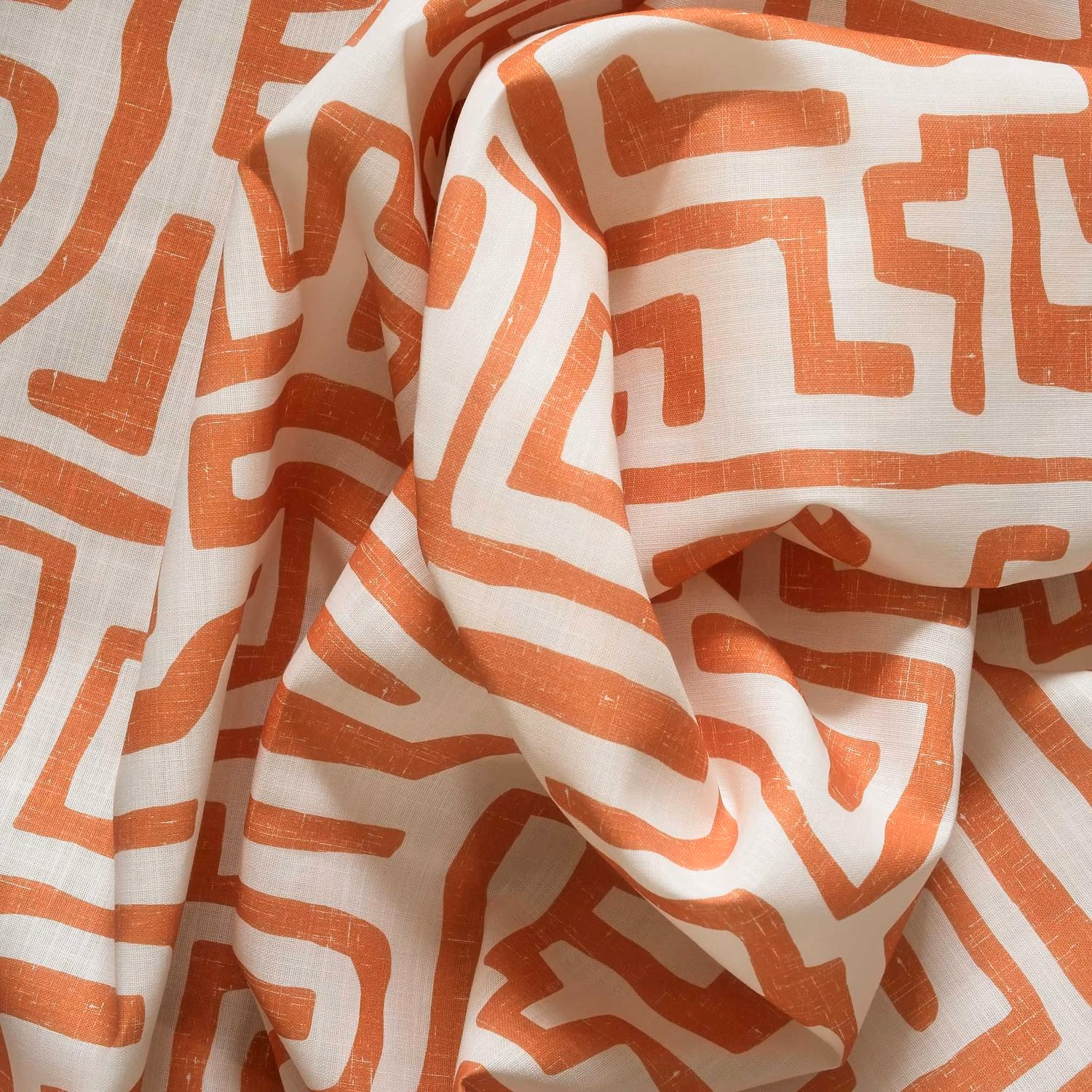 Terracotta maze-like lines on a softly textured white woven ground