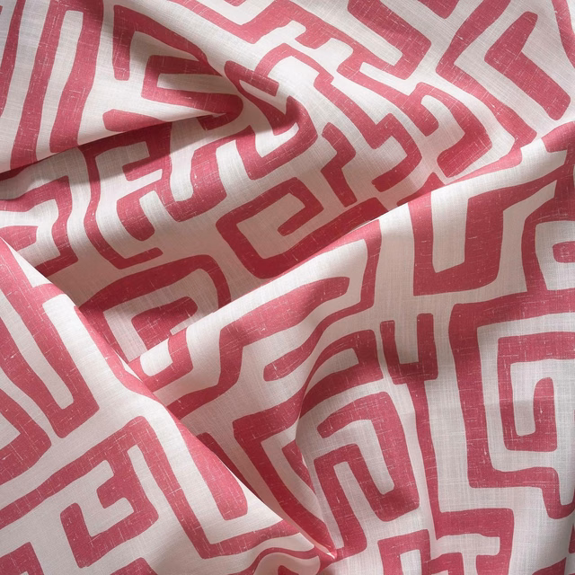 Cream woven outdoor fabric with raspberry-pink maze lines in gathered folds
