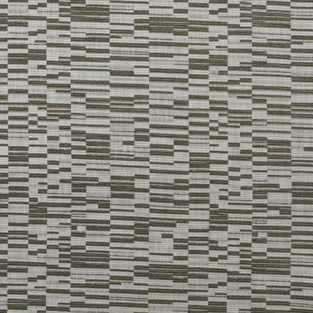 Close-up of ribbed grey fabric with irregular pale and charcoal rectangular blocks