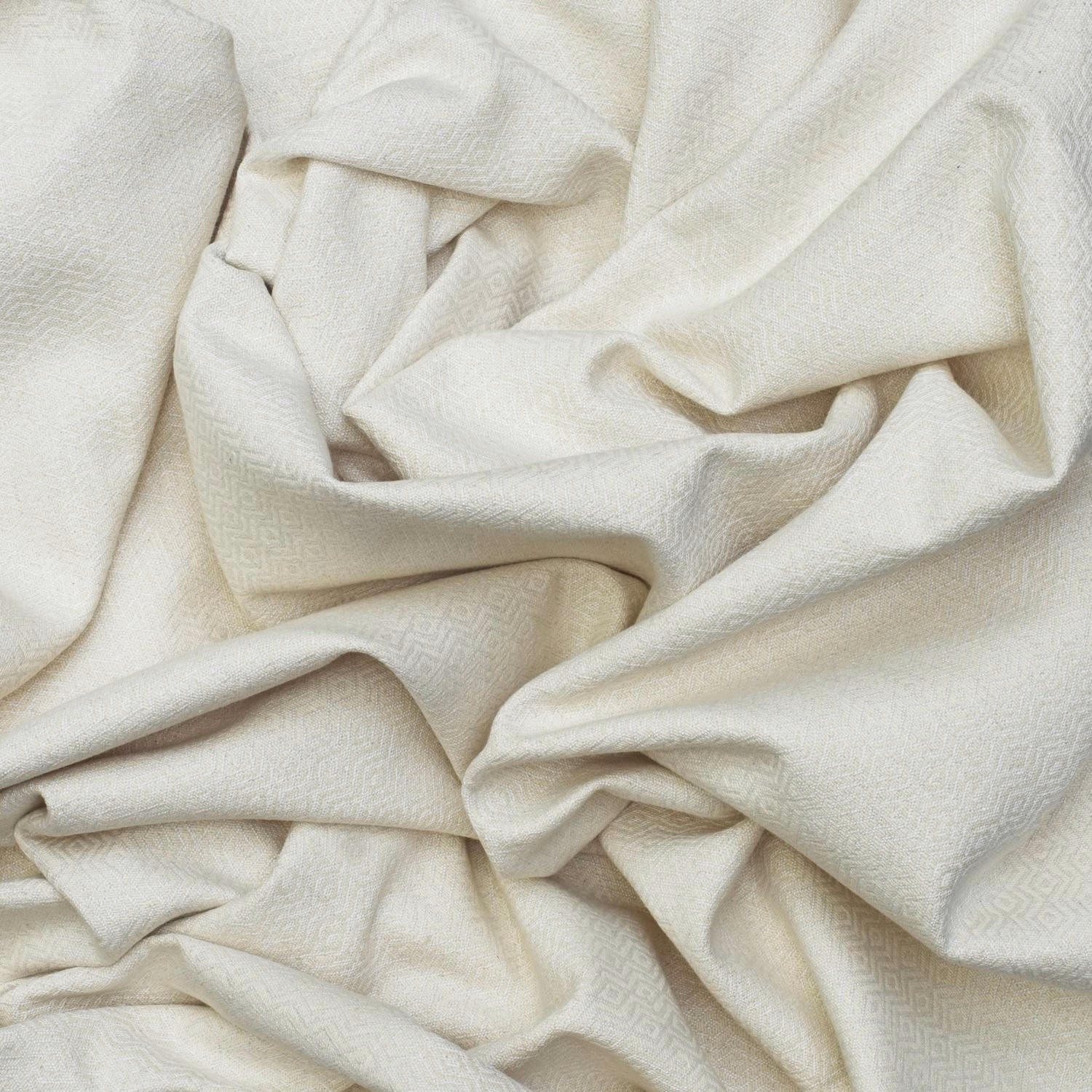 Chalk ivory fabric with tiny tonal ikat motifs and a softly textured surface