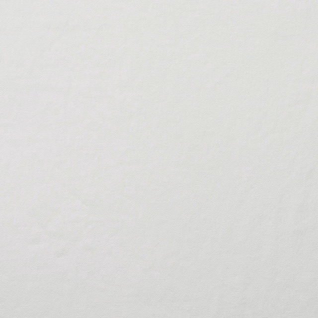 Close-up of cool snow-white fabric with a fine, subtly textured plain weave
